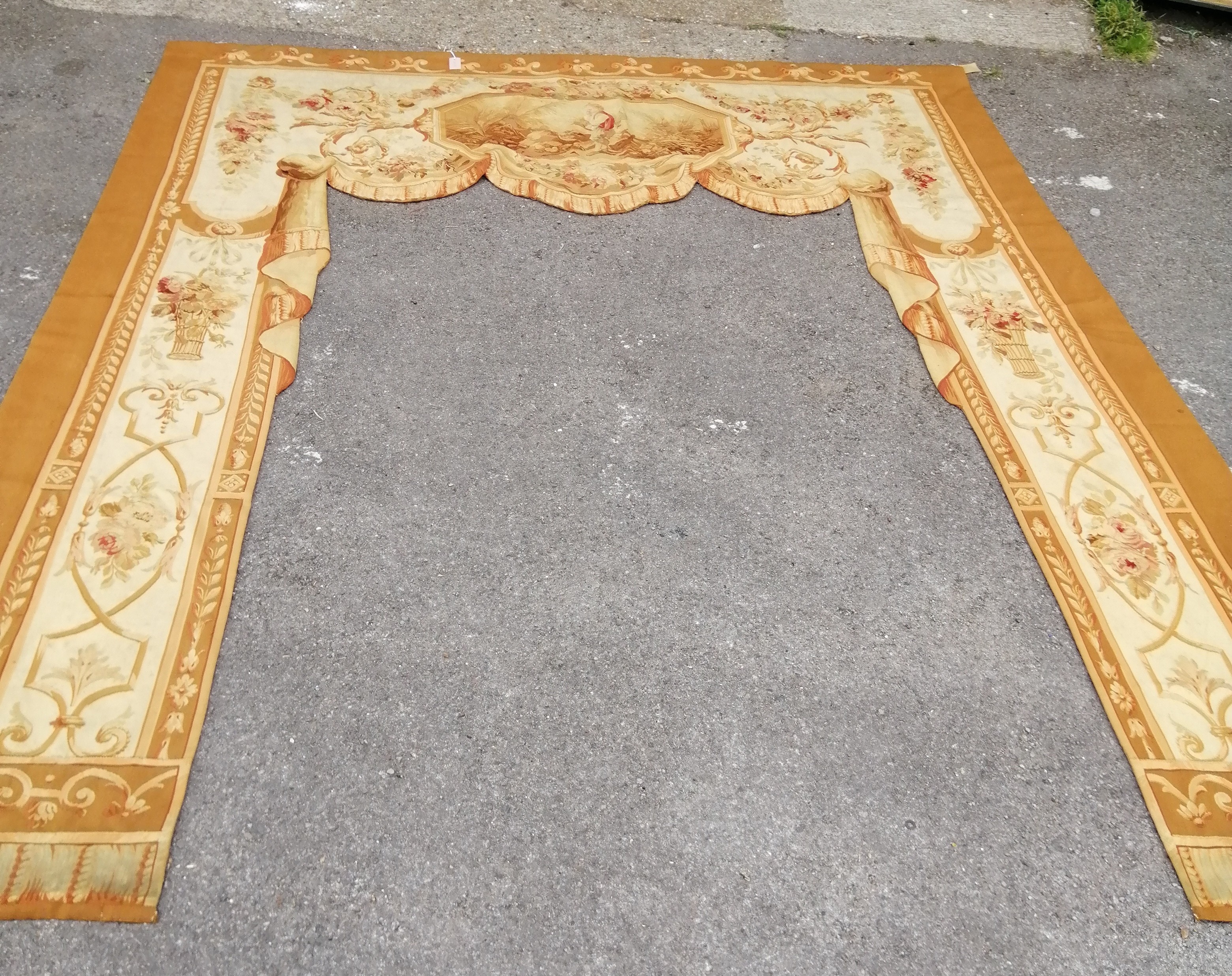 A French tapestry door surround woven with an octagonal vignette, floral swags and baskets of flowers, width 254cm height approximately 300cm